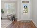 Inviting foyer featuring wood floors, a neutral color palette, and a view of the front door at 1127 Timbercut Dr, Durham, NC 27703