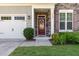 Close-up of the front door, showing the stone facade and well-kept landscaping at 1127 Timbercut Dr, Durham, NC 27703