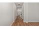Long hallway with wood floors and neutral paint, leading to other rooms in the home at 1127 Timbercut Dr, Durham, NC 27703