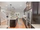 Modern kitchen featuring stainless steel appliances, center island, and an open layout to the living area at 1127 Timbercut Dr, Durham, NC 27703