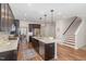 Spacious kitchen featuring dark cabinets, granite countertops, a large island, and modern appliances at 1127 Timbercut Dr, Durham, NC 27703