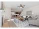 Open concept living room boasts lots of light, stylish furniture, and opens to a modern kitchen and dining area at 1127 Timbercut Dr, Durham, NC 27703