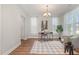 Cozy living room with stylish decor, wood floors, and ample natural light from the windows at 1127 Timbercut Dr, Durham, NC 27703