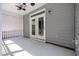 A covered porch area featuring a ceiling fan and double doors leading inside at 1127 Timbercut Dr, Durham, NC 27703