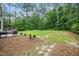 View of backyard, patio area, bordered with lush greenery at 117 Garden Oaks Dr, Smithfield, NC 27577