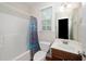 Bright bathroom with a bathtub, shower, toilet, vanity, and window for natural light at 117 Garden Oaks Dr, Smithfield, NC 27577