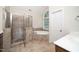 Bright bathroom with glass shower, soaking tub, and arched window at 117 Garden Oaks Dr, Smithfield, NC 27577