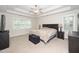 Spacious main bedroom with tray ceiling, ceiling fan, and plenty of natural light at 117 Garden Oaks Dr, Smithfield, NC 27577