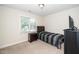 A bedroom featuring a window, side table, TV on a dresser, and a bed at 117 Garden Oaks Dr, Smithfield, NC 27577