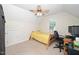 An upstairs bedroom features a window, a ceiling fan, and an office space setup at 117 Garden Oaks Dr, Smithfield, NC 27577