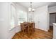 Bright breakfast nook with natural light, hardwood floors, and classic décor at 117 Garden Oaks Dr, Smithfield, NC 27577