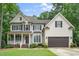 Traditional two-story home with a porch, dormers, and attached garage at 117 Garden Oaks Dr, Smithfield, NC 27577
