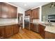 Spacious kitchen with stainless appliances, granite countertops, and rich wood cabinetry at 117 Garden Oaks Dr, Smithfield, NC 27577