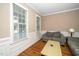 Cozy living room with wainscoting, neutral walls, and hardwood flooring at 117 Garden Oaks Dr, Smithfield, NC 27577