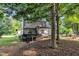 View of backyard with lush foliage, wooden deck, and shade trees at 120 Feezor Ct, Clayton, NC 27527
