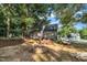 Spacious backyard featuring a fire pit, seating area, and mature trees for shade at 120 Feezor Ct, Clayton, NC 27527