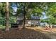 View of home's backyard with spacious deck, seating area, and mature trees offering shade at 120 Feezor Ct, Clayton, NC 27527