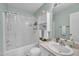 Bathroom with a shower/tub combo, light green walls and cream vanity at 120 Feezor Ct, Clayton, NC 27527