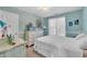 Bright bedroom featuring a comfortable bed with white linens, a dresser, and ample natural light from the large window at 120 Feezor Ct, Clayton, NC 27527
