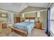 Cozy bedroom featuring a wooden bed frame with bench, complemented by matching nightstands and a ceiling fan at 120 Feezor Ct, Clayton, NC 27527