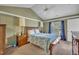 Relaxing bedroom featuring a cozy bed with matching wooden furniture, complemented by a large window with natural light at 120 Feezor Ct, Clayton, NC 27527