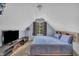 Bedroom features a plush bed, TV, carpet, and an inviting window at 120 Feezor Ct, Clayton, NC 27527