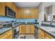 Well-equipped kitchen with stainless steel appliances, wooden cabinets, ample counter space, and under cabinet blue lighting at 120 Feezor Ct, Clayton, NC 27527