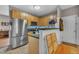 Kitchen with stainless steel refrigerator, light wood cabinets and green countertops at 120 Feezor Ct, Clayton, NC 27527