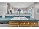 Bright kitchen featuring a double basin sink with teal countertop and wooden cabinets, offering a fresh and functional design at 120 Feezor Ct, Clayton, NC 27527