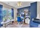 Bright office featuring blue accent wall, shelving, desk, and window at 120 Feezor Ct, Clayton, NC 27527