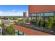 View of an outdoor lounge area with a table set against the backdrop of the city skyline at 122 N Harrington St # 1555, Raleigh, NC 27603