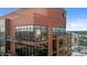 Close up of a tall brick building with expansive windows and a balcony overlooking an urban landscape at 122 N Harrington St # 1555, Raleigh, NC 27603