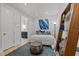 Stylish bedroom featuring hardwood floors, modern art, and a cozy aesthetic with decorative shelving at 122 N Harrington St # 1555, Raleigh, NC 27603