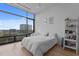 Bright bedroom with modern decor, bookshelf, and a large window overlooking the cityscape at 122 N Harrington St # 1555, Raleigh, NC 27603