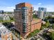 Brick exterior of a high-rise building with many windows, surrounded by lush green trees in an urban setting at 122 N Harrington St # 1555, Raleigh, NC 27603