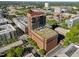 View of Quorum Center, a brick building with a green roof, surrounded by the city at 122 N Harrington St # 1555, Raleigh, NC 27603