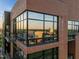 Exterior angle showcasing the large windows reflecting the city skyline at 122 N Harrington St # 1555, Raleigh, NC 27603