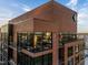 Corner facade detail showcasing expansive windows and brick exterior, creating a modern and stylish urban residence at 122 N Harrington St # 1555, Raleigh, NC 27603