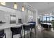 Modern kitchen features stainless steel appliances, waterfall island with barstool seating and pendant lighting at 122 N Harrington St # 1555, Raleigh, NC 27603