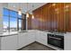 Modern kitchen with sleek white cabinets, stainless steel appliances, and a view at 122 N Harrington St # 1555, Raleigh, NC 27603