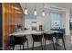 Open kitchen features a waterfall island, pendant lighting, and stainless steel appliances at 122 N Harrington St # 1555, Raleigh, NC 27603