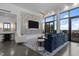 Bright, modern living room with large TV, stylish wallpaper, floor-to-ceiling windows, and elegant furniture at 122 N Harrington St # 1555, Raleigh, NC 27603