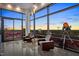 Sun-lit room with large windows showcasing city views, lounge chairs, and access to the outdoor terrace at 122 N Harrington St # 1555, Raleigh, NC 27603