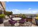Relax on this spacious patio with an outdoor table, chairs, and lush greenery overlooking city views at 122 N Harrington St # 1555, Raleigh, NC 27603