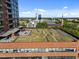 Overhead view of a building's rooftop garden featuring green grass, stone pavers, and outdoor seating at 122 N Harrington St # 1555, Raleigh, NC 27603