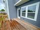 Back deck with wooden decking, gray siding, and an outdoor light fixture at 124 Sugar Run Dr # 11, Fuquay Varina, NC 27526