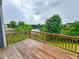 Wooden back deck overlooking a scenic view of a lake surrounded by trees at 124 Sugar Run Dr # 11, Fuquay Varina, NC 27526