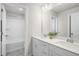 Contemporary bathroom featuring a double vanity with white cabinets, tile floors, and tub at 124 Sugar Run Dr # 11, Fuquay Varina, NC 27526
