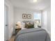Comfortable bedroom features a patterned comforter, side tables, and a large window with natural light at 124 Sugar Run Dr # 11, Fuquay Varina, NC 27526