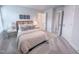 Bright bedroom featuring a striped comforter, carpet, side table, and windows for natural light at 124 Sugar Run Dr # 11, Fuquay Varina, NC 27526